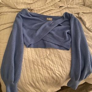 crossed sweater